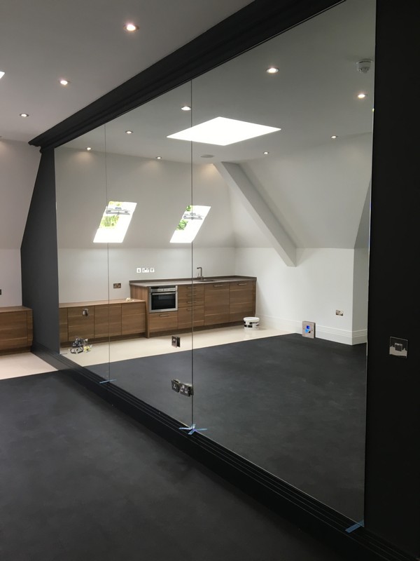 Frameless glass partition in loft conversion by Thame glaziers