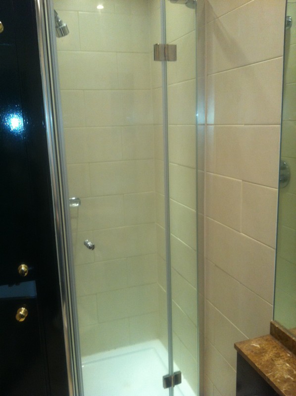 Frameless glass shower enclosure with chrome fittings in Thame